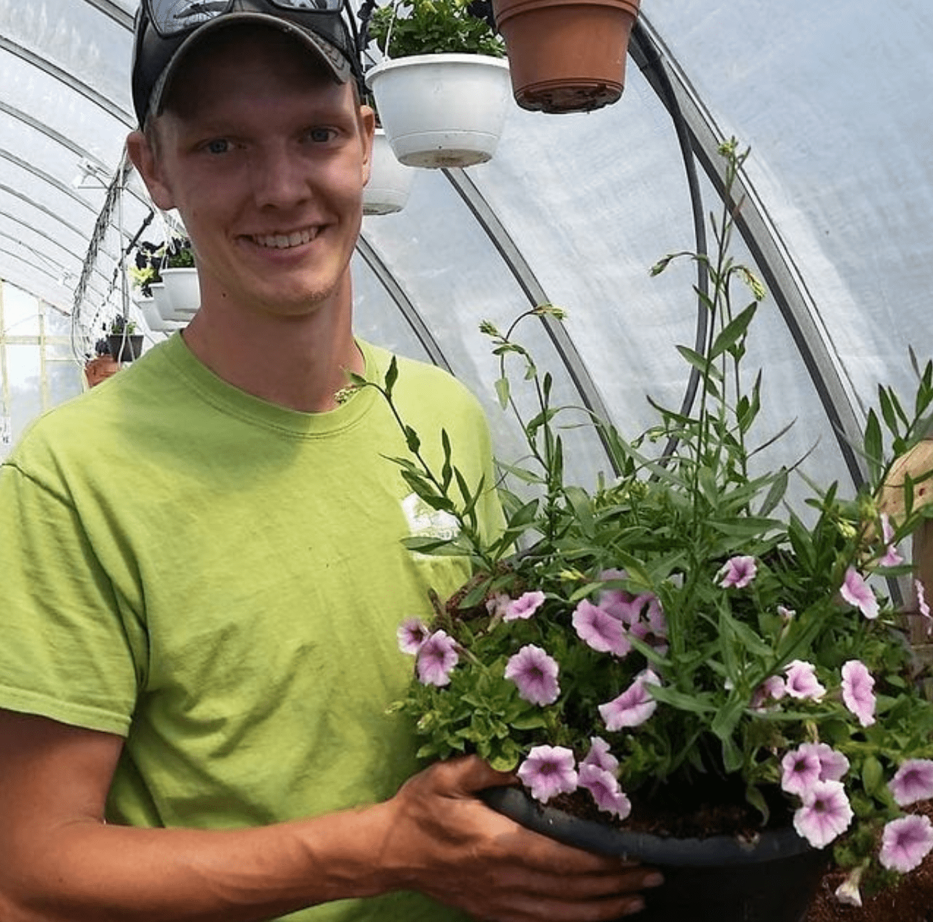 Tyler Harber holing a potted plant